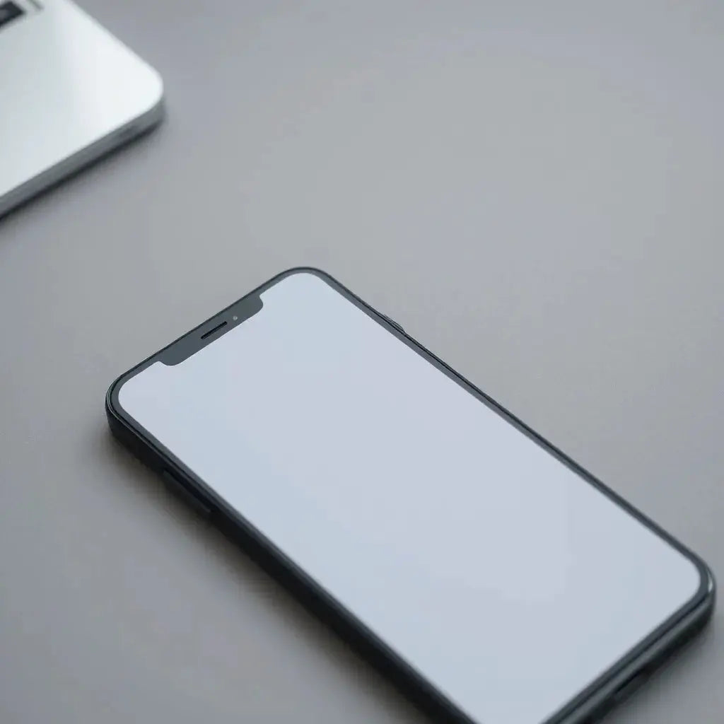 Smartphone screen with a matte finish protector aligned on a neutral surface under soft lighting