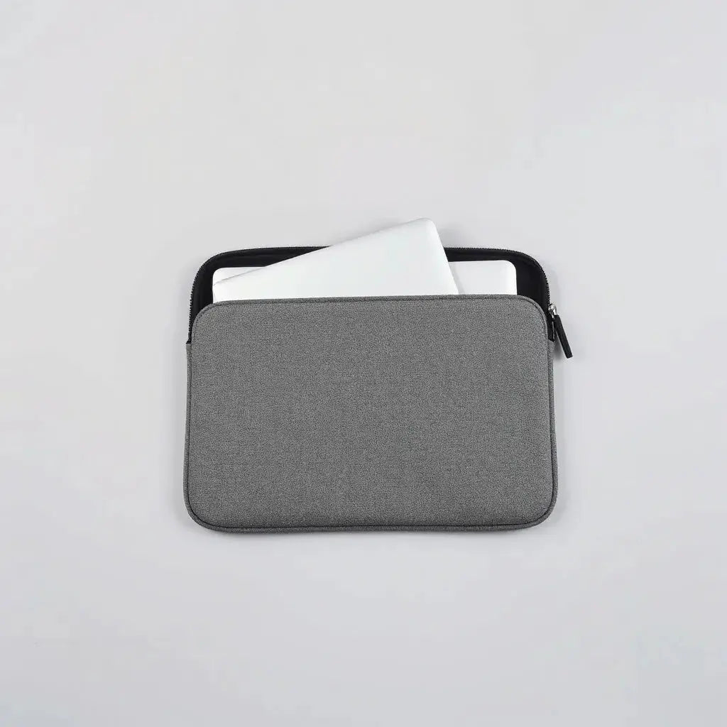 Neoprene laptop sleeve with a slim laptop placed inside on a clean light background
