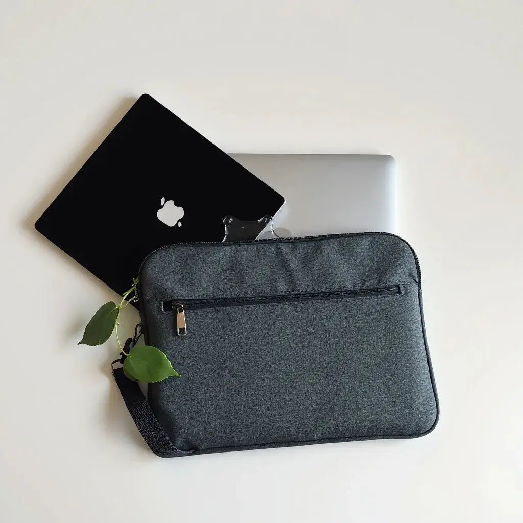 Water-resistant laptop sleeve with zipper and padded interior next to a laptop on a clean surface