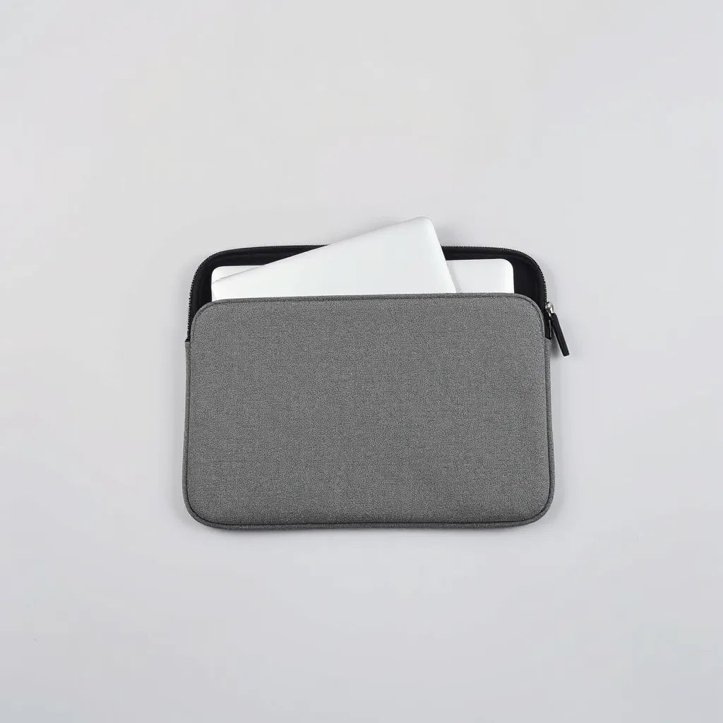 Neoprene laptop sleeve with a slim laptop placed inside on a clean light background